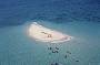 Snorkel in clear shallow waters surrounding the Cay